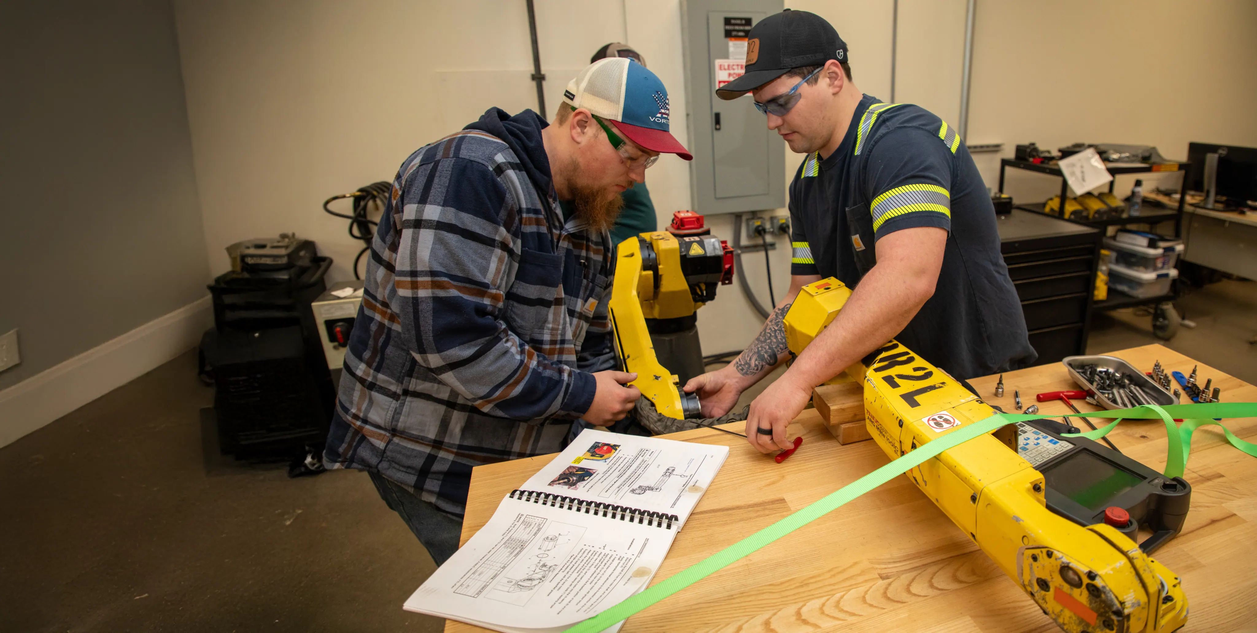 Students working with robotics equipment in a technical lab